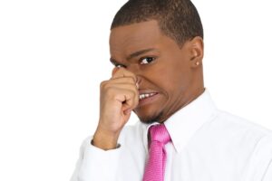 Stinks. Man pinches his nose, doesn't like bad smell